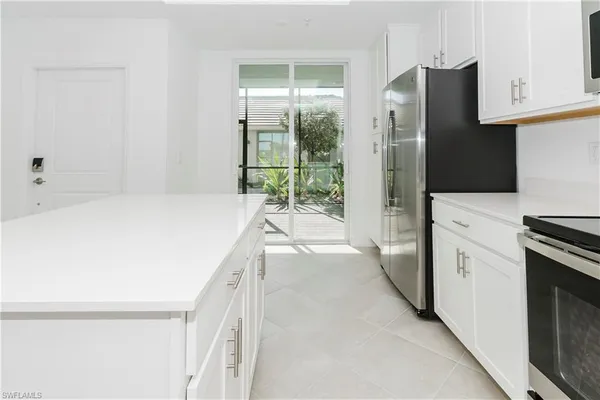 a kitchen with a refrigerator and a sink