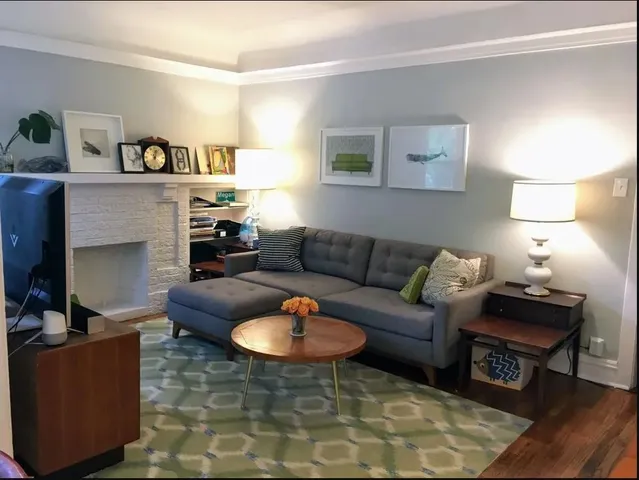 a living room with furniture and a fireplace