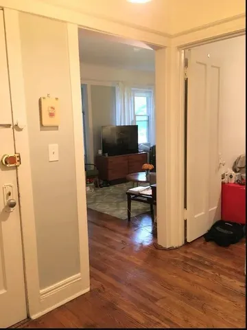 a living room with furniture and a mirror