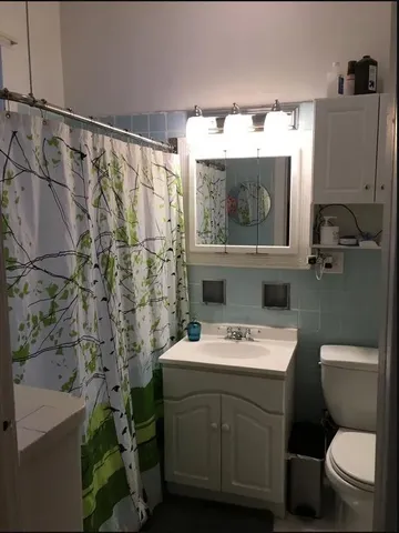 a bathroom with a sink a toilet and a mirror