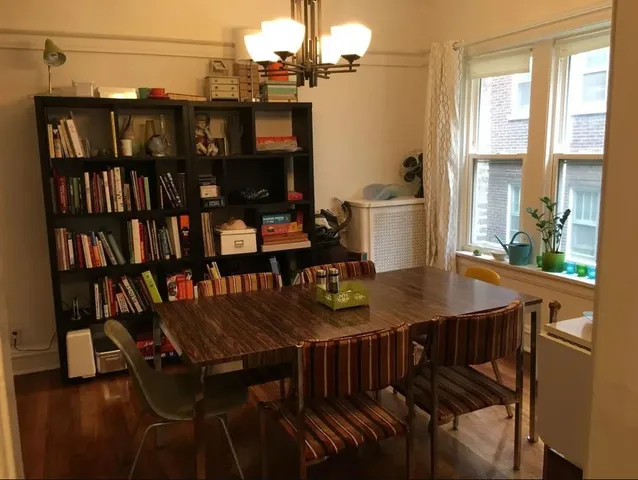 a view of a dining room with furniture and a window