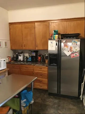 a kitchen with stainless steel appliances a refrigerator and a stove