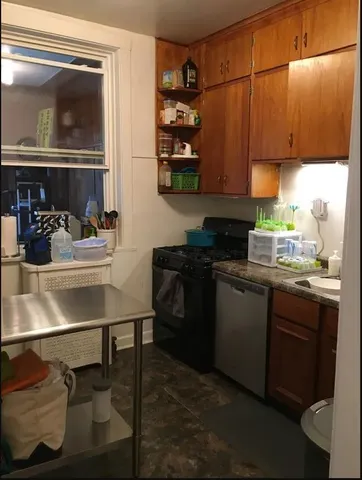 a kitchen with a sink cabinets and window