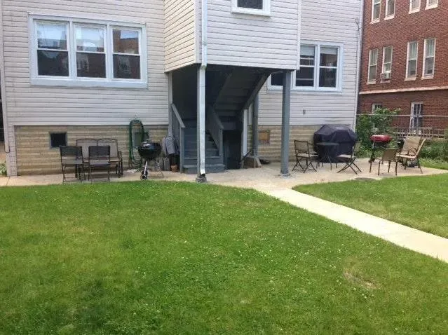 a view of a chair and table in the backyard