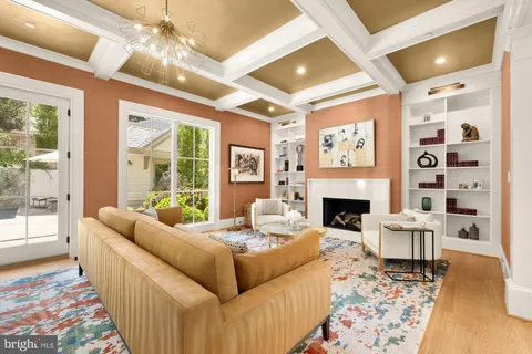 a dining hall with couches a dining table and chairs with wooden floor