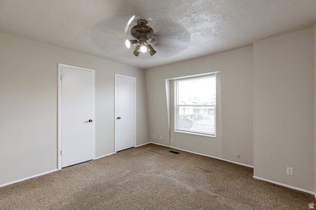 88 West 50 South, Unit J10 Centerville, UT 84014 - Photo 11 of 19 Neutral-toned room featuring a single window and two white doors