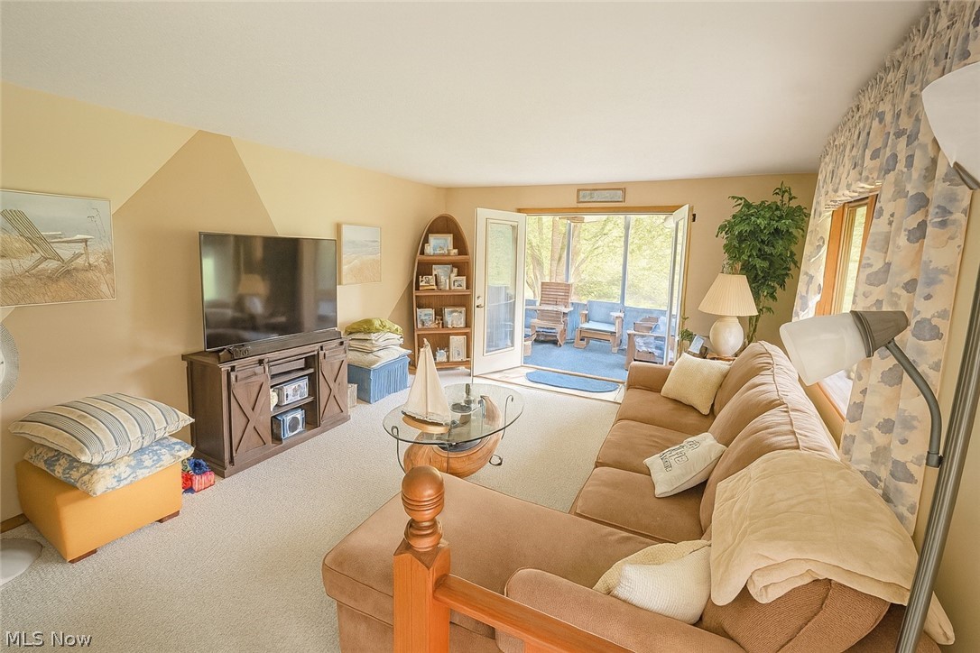 53310 Mud Run Road Senecaville, OH 43780 - Photo 2 of 28 View of carpeted living area with entry to screened porch