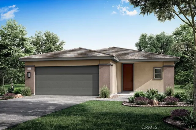 a front view of a house with a garden and plants