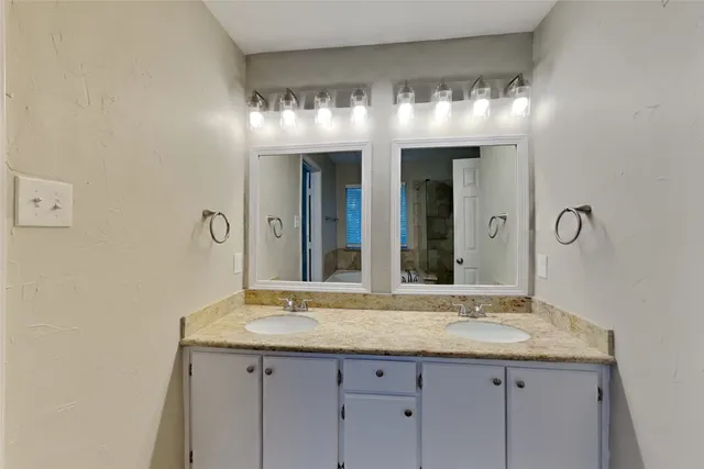 a bathroom with a sink and a large mirror
