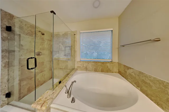 a bathroom with a bathtub and shower