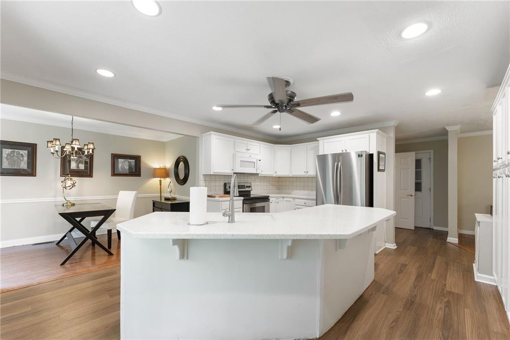4601 North Browning Bridge Road Gainesville, GA 30506 - Photo 68 of 80 a large white kitchen with a table and chairs