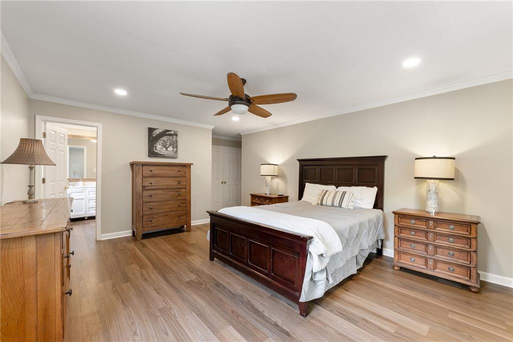 4601 North Browning Bridge Road Gainesville, GA 30506 - Photo 70 of 80 a bedroom with a bed and a chandelier