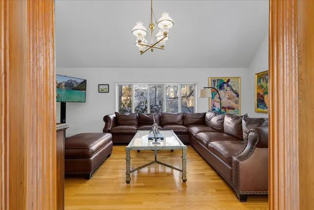 a spacious bedroom with a bed and wooden floor