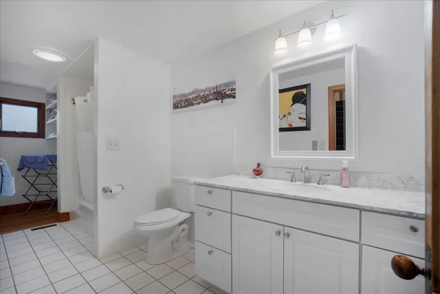 a spacious bedroom with a bed and a couch