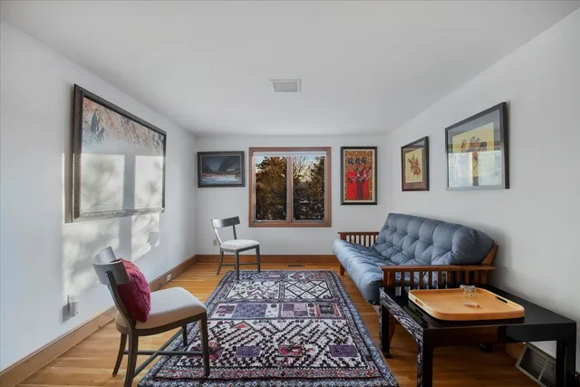 a living room with a bed furniture and a window