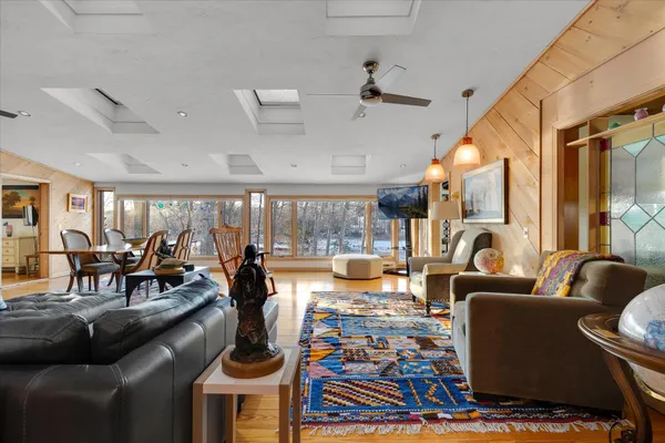 a view of living room with furniture and a painting on the wall