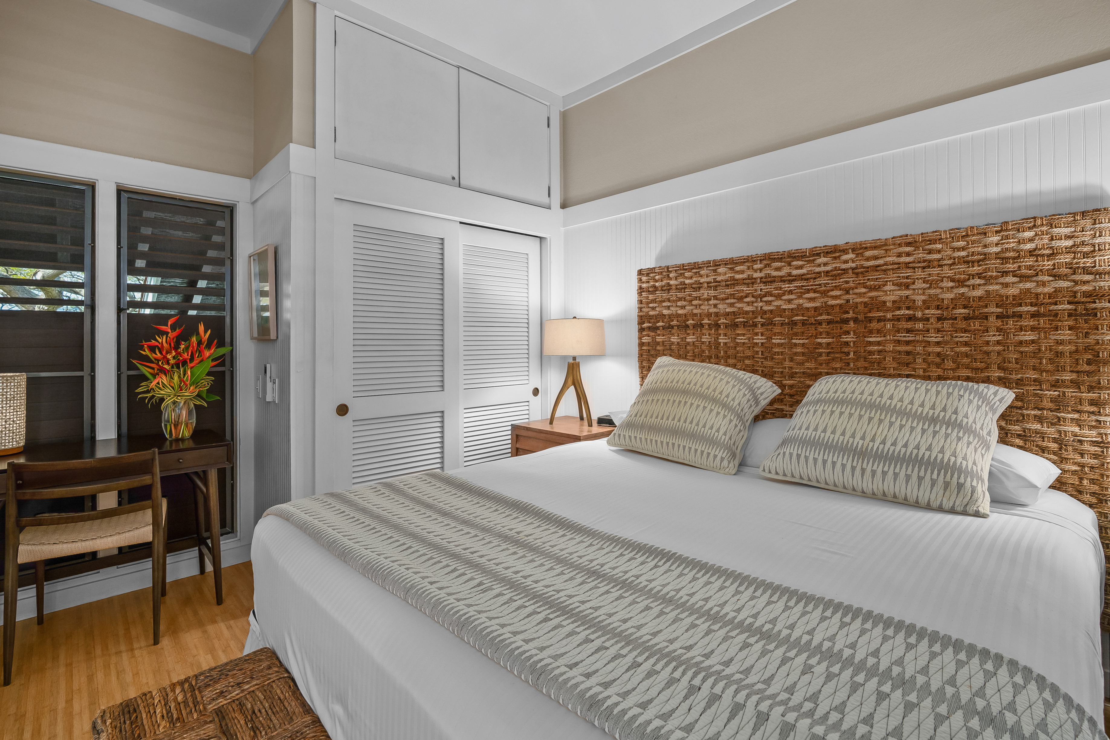 2253 Poipu Road, Unit 123 Koloa, HI 96756 - Photo 16 of 25 a bedroom with a bed table and a flat screen tv