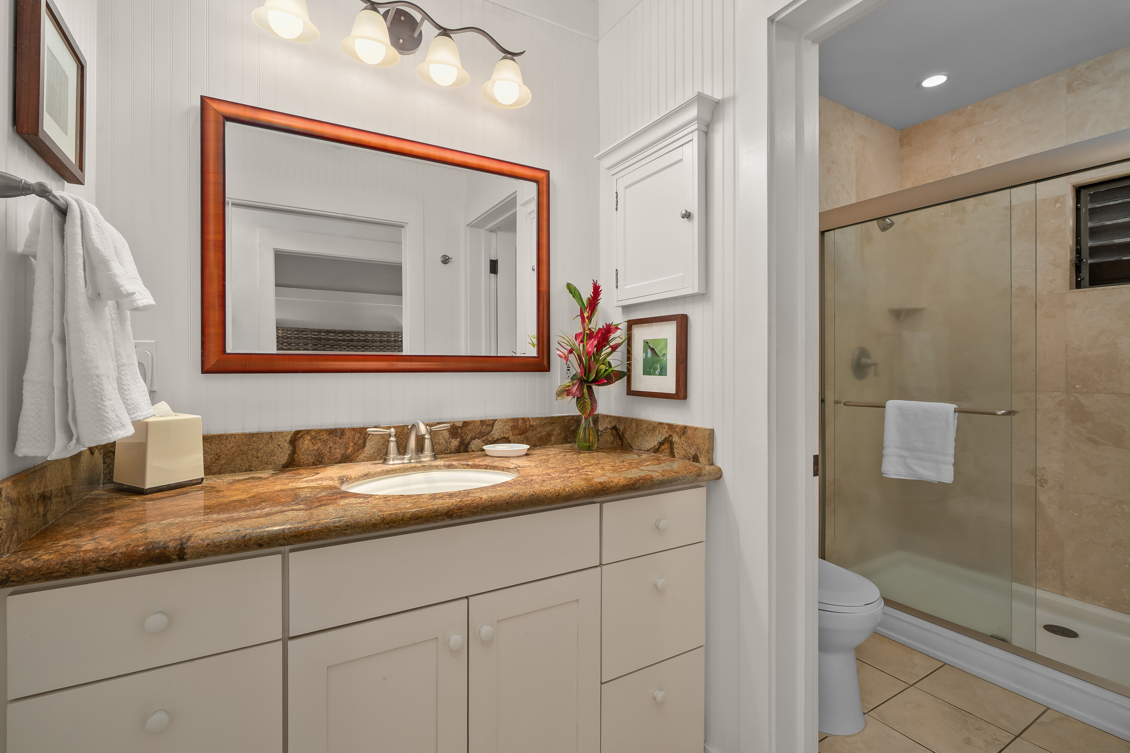 2253 Poipu Road, Unit 123 Koloa, HI 96756 - Photo 18 of 25 a bathroom with a granite countertop double vanity sink and mirror