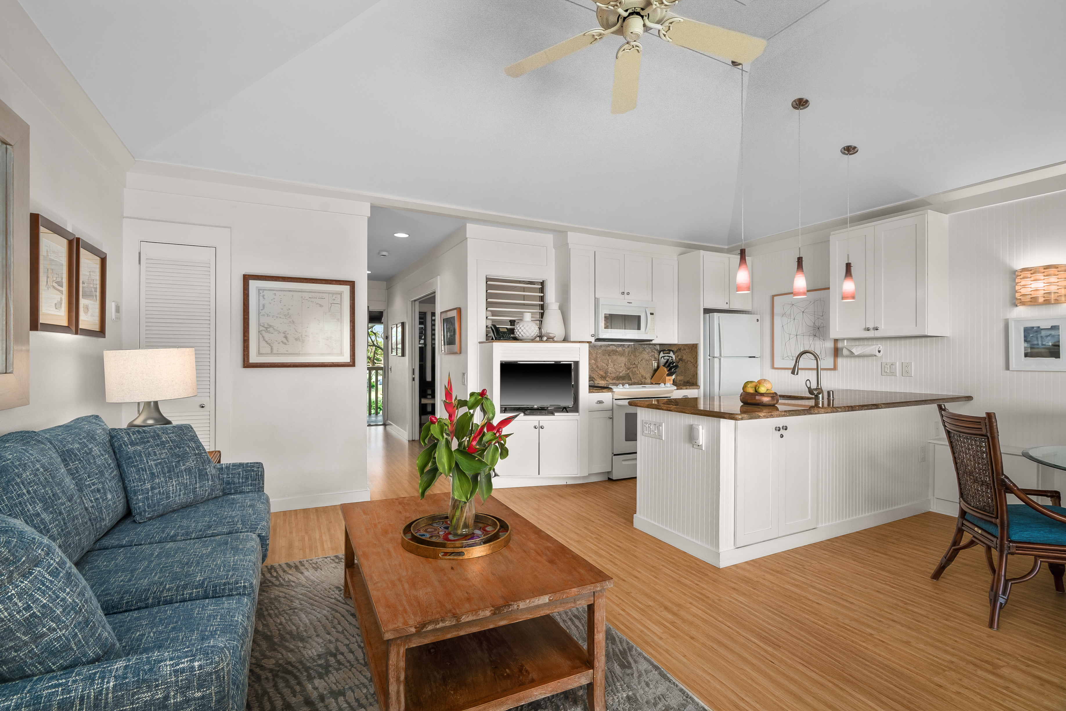2253 Poipu Road, Unit 123 Koloa, HI 96756 - Photo 10 of 25 a living room with furniture a fireplace and a chandelier