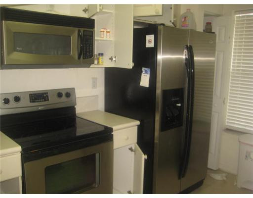 14005 Southwest 49th Street, Unit 9 Miramar, FL 33027 - Photo 3 of 5 a kitchen with a refrigerator stove and microwave