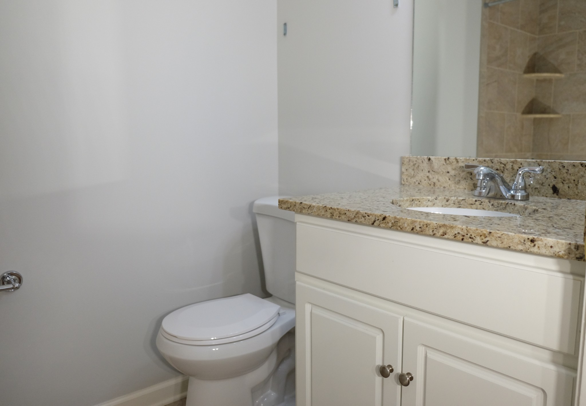 2810 Valley Road Nashville, TN 37215 - Photo 7 of 10 a bathroom with a granite countertop toilet sink and mirror