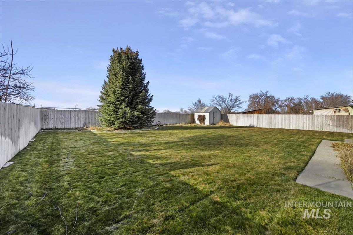 125 Sunset Circle Buhl, ID 83316 - Photo 17 of 17 Fenced backyard featuring a storage shed