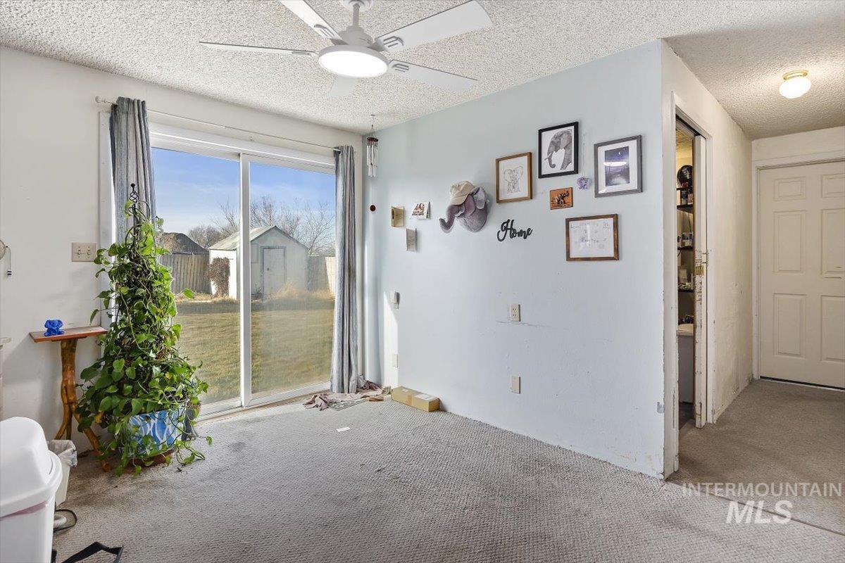 125 Sunset Circle Buhl, ID 83316 - Photo 6 of 17 Carpeted spare room with a ceiling fan and a textured ceiling