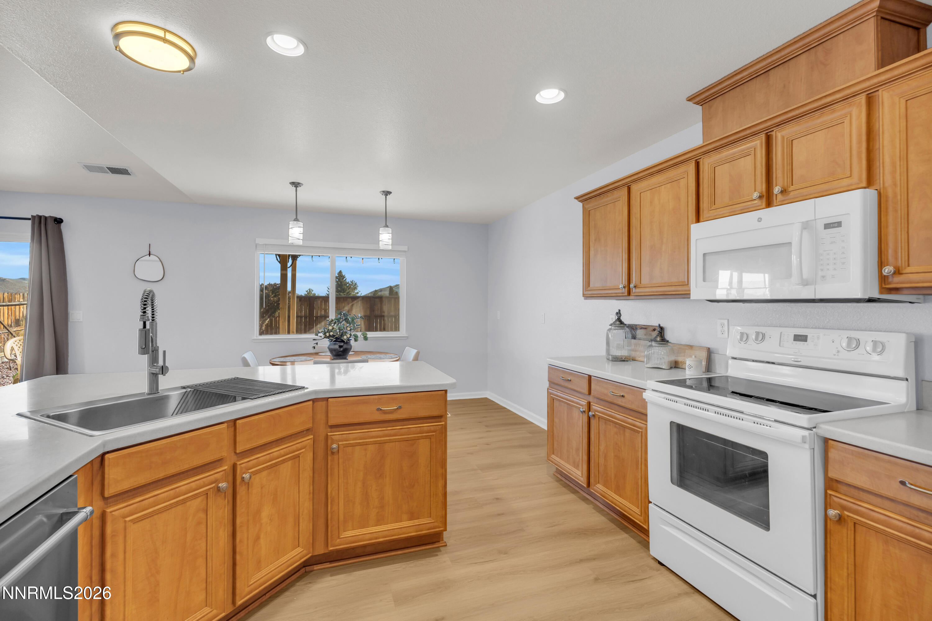 9834 Suncrest Drive Reno, NV 89506 - Photo 12 of 32 a kitchen with a sink stove and cabinets