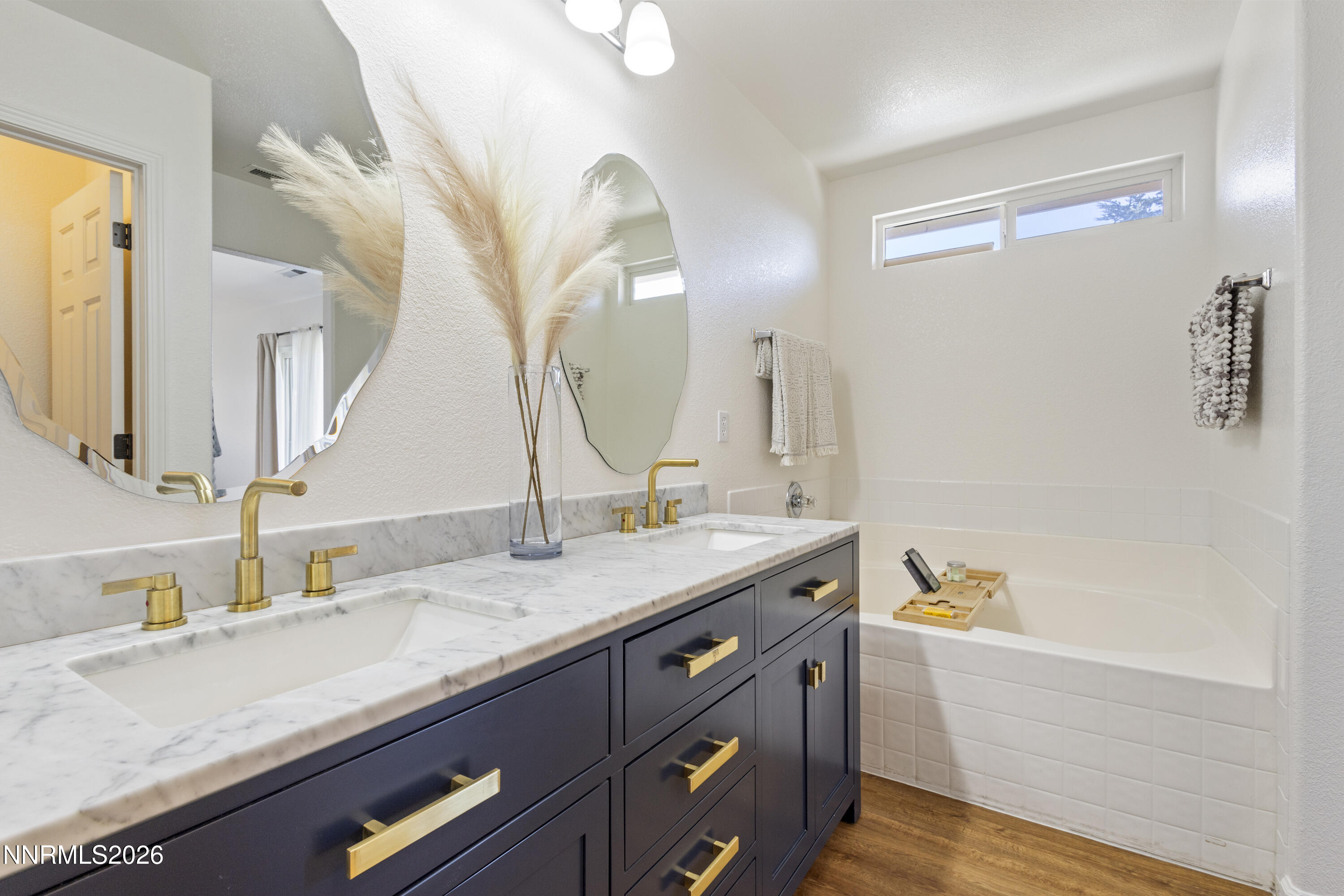9834 Suncrest Drive Reno, NV 89506 - Photo 18 of 32 a bathroom with a granite countertop double vanity sink and a mirror