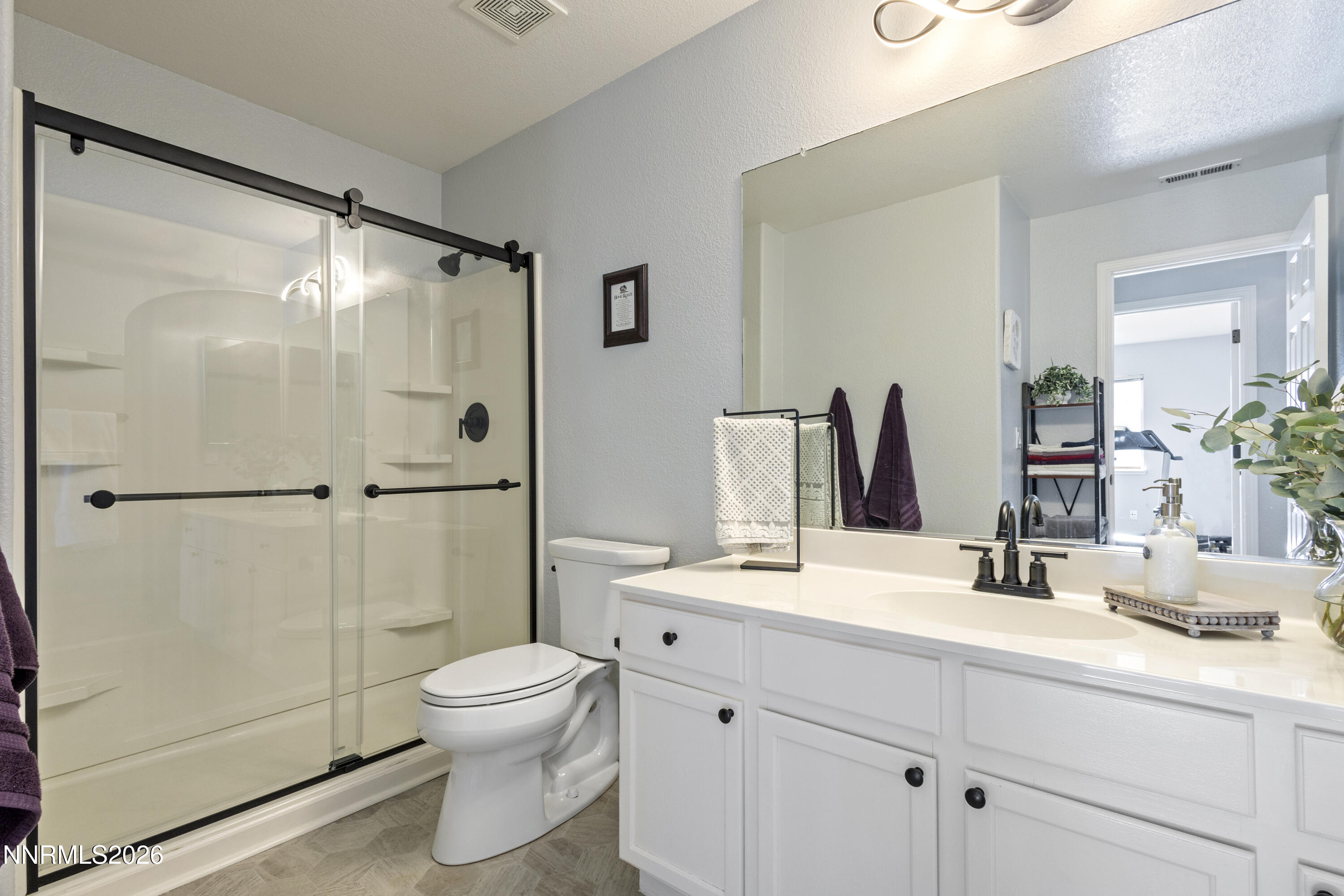 9834 Suncrest Drive Reno, NV 89506 - Photo 23 of 32 a bathroom with a toilet sink and shower
