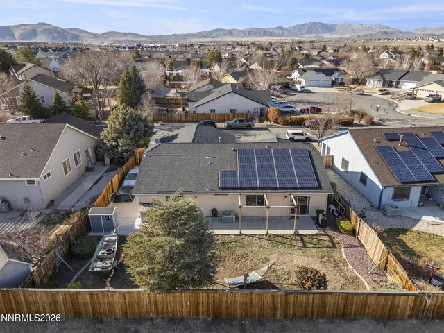 an aerial view of residential houses with outdoor space and swimming pool