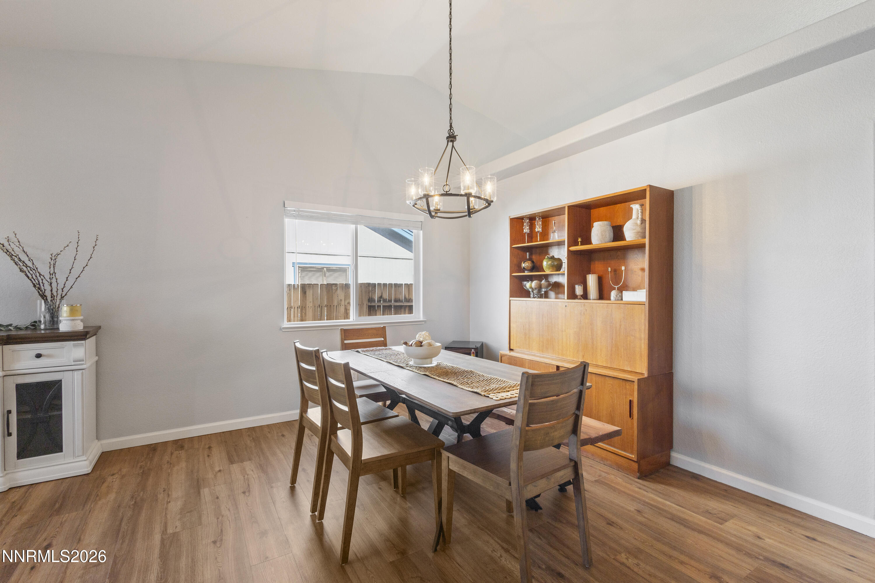 9834 Suncrest Drive Reno, NV 89506 - Photo 6 of 32 a dining room with furniture a chandelier and wooden floor