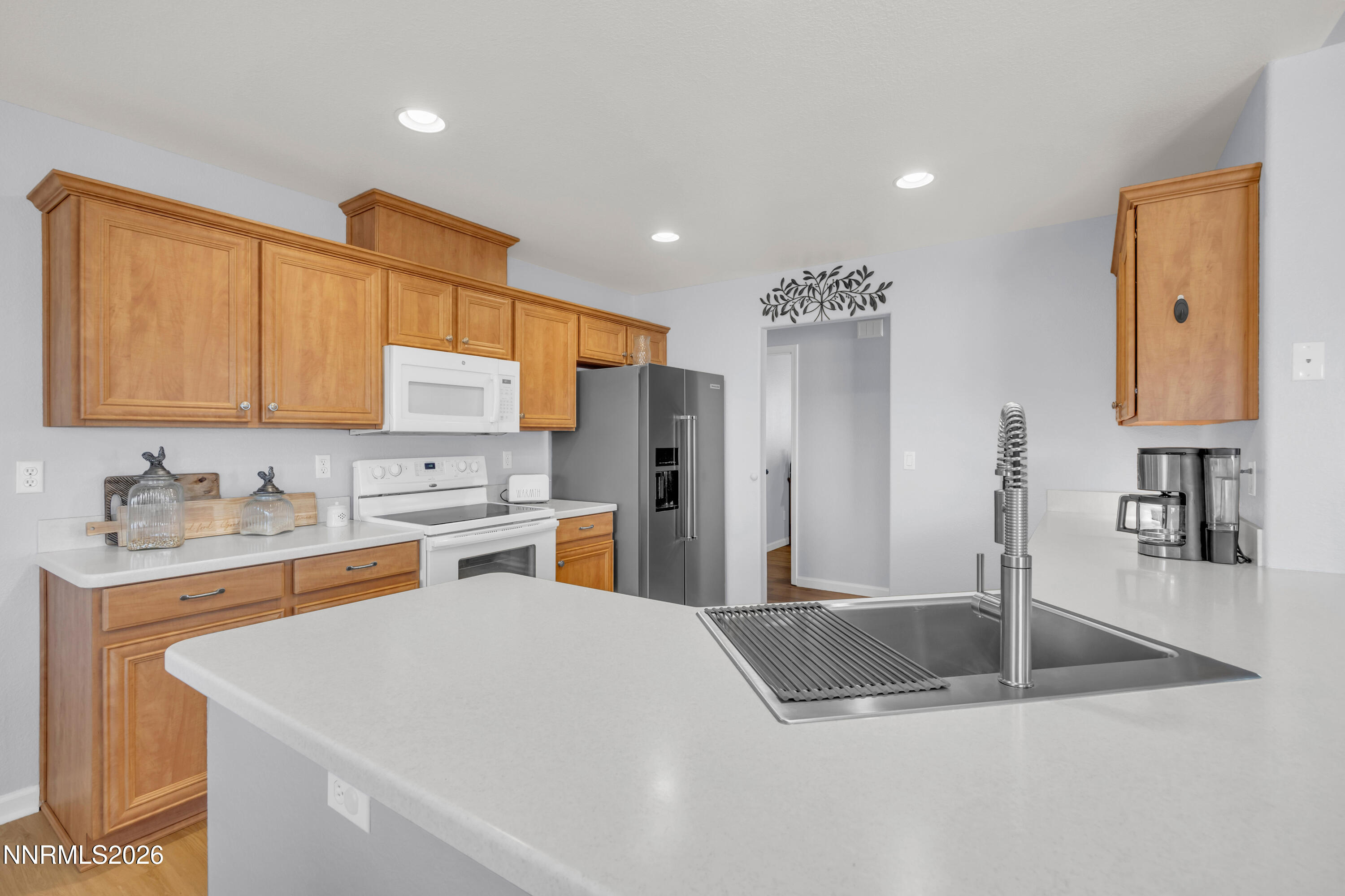 9834 Suncrest Drive Reno, NV 89506 - Photo 7 of 32 a kitchen with stainless steel appliances granite countertop a sink a stove and refrigerator