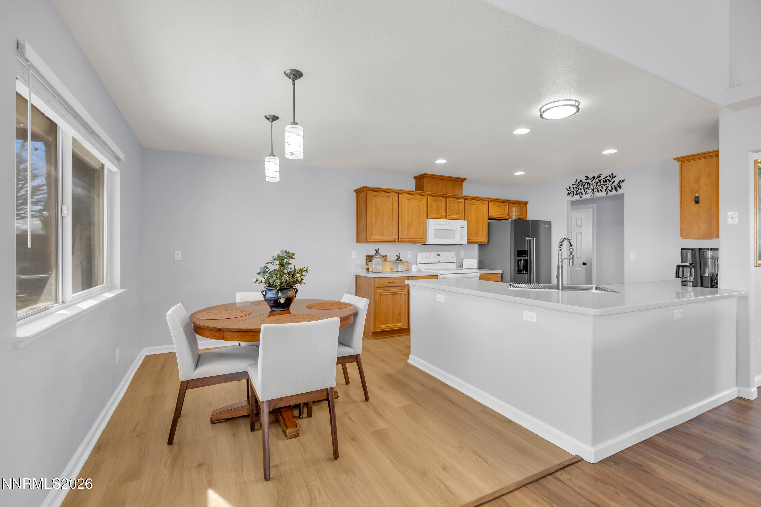 9834 Suncrest Drive Reno, NV 89506 - Photo 10 of 32 a kitchen with stainless steel appliances kitchen island granite countertop a dining table chairs and granite counter tops