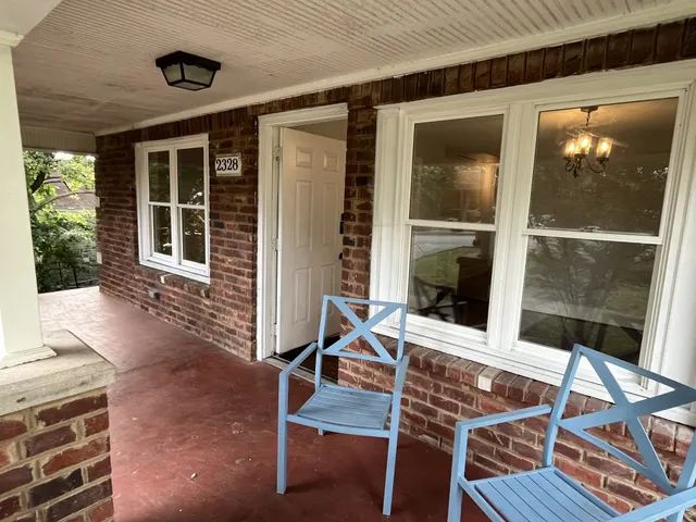 front view of house with a chairs and table in the patio