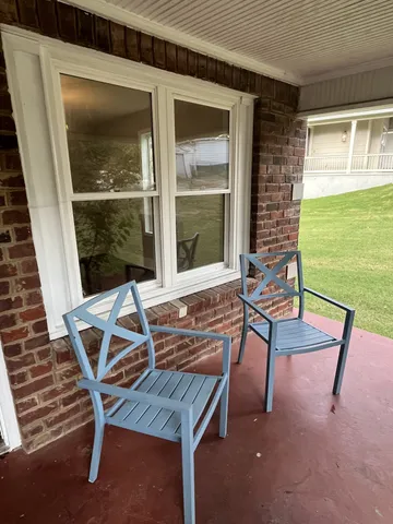 a balcony with table and chairs