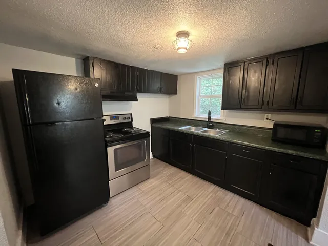 a kitchen with a refrigerator and a sink