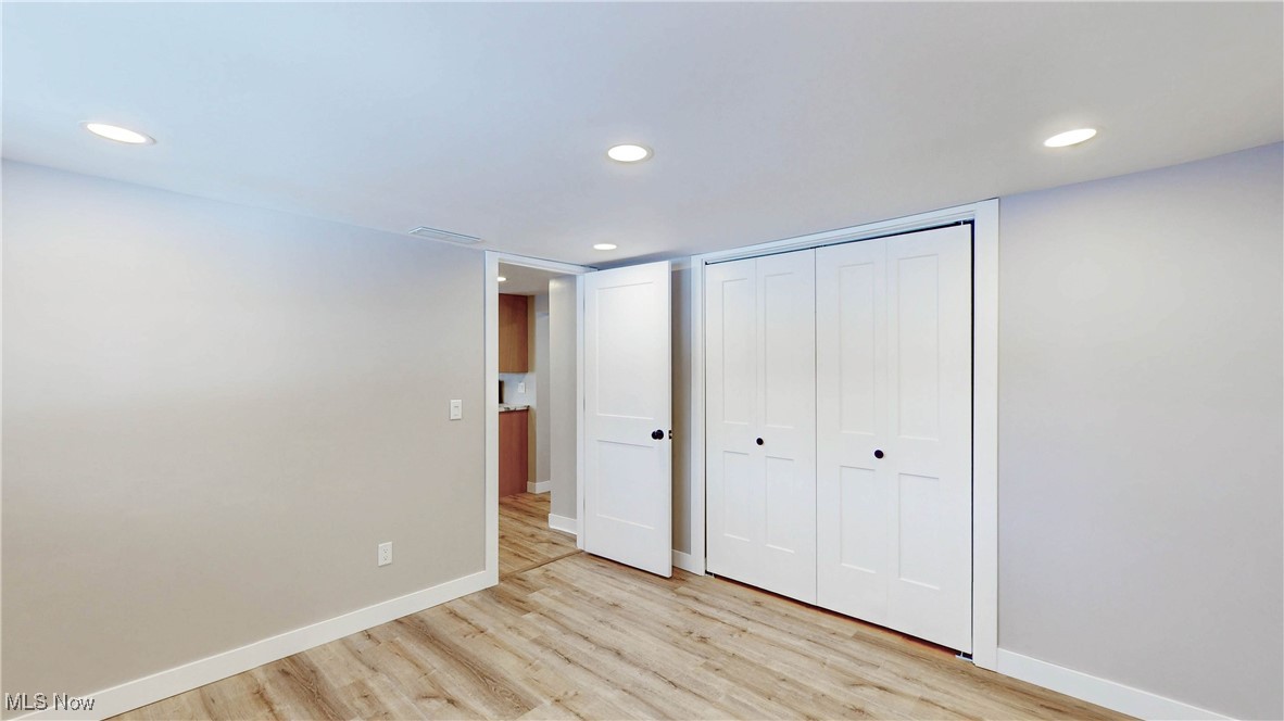2978 Long Road Uniontown, OH 44685 - Photo 20 of 40 Unfurnished bedroom featuring recessed lighting, a closet, and light wood-style floors