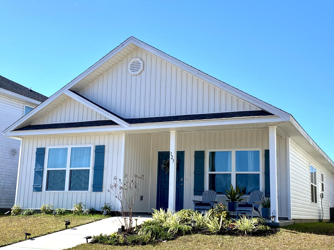 123 Staggerbush Street Freeport, FL 32439 - Photo 5 of 7 a front view of a house with garden
