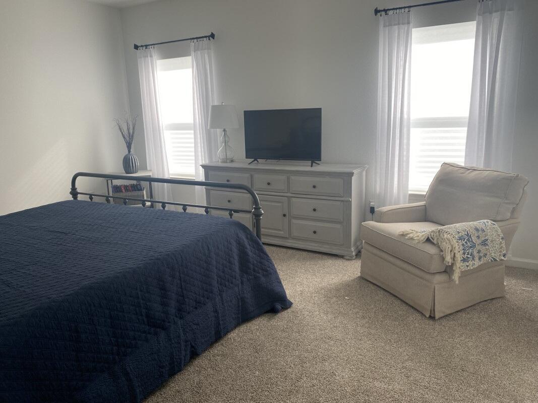 123 Staggerbush Street Freeport, FL 32439 - Photo 7 of 7 a bedroom with a bed and a flat screen tv