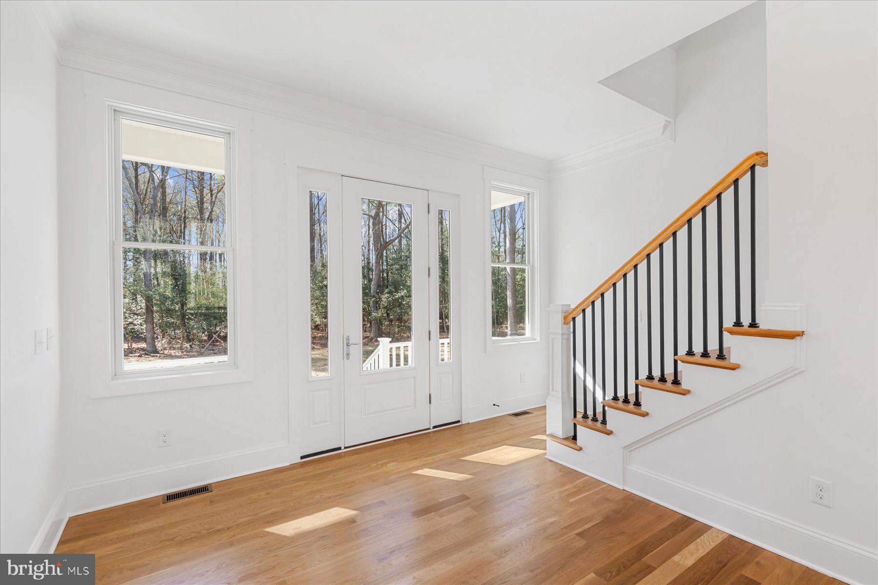 30425 Hollymount Road Harbeson, DE 19951 - Photo 11 of 98 a view of an entryway with wooden floor and windows