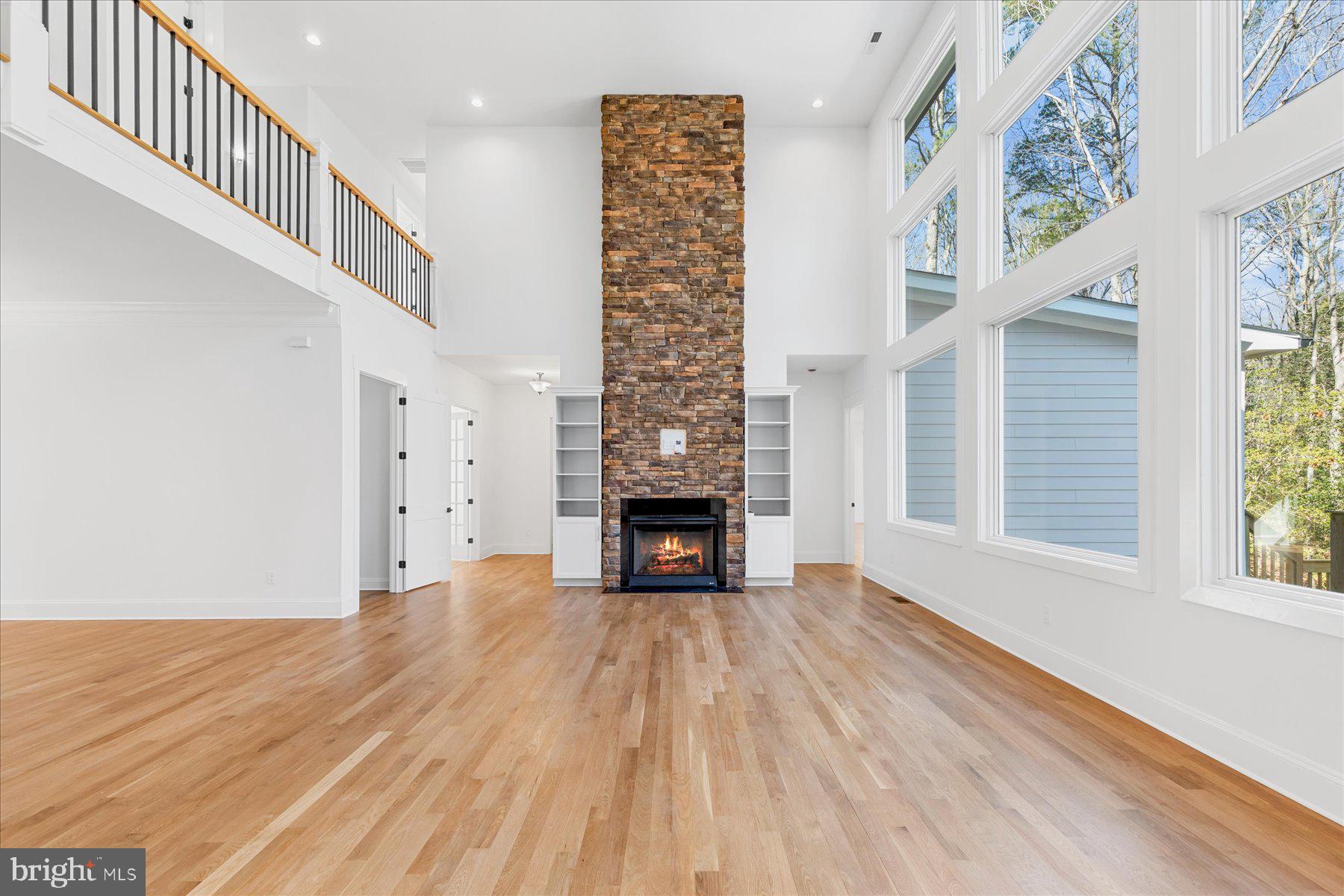 30425 Hollymount Road Harbeson, DE 19951 - Photo 16 of 98 a view of an empty room with wooden floor fireplace and windows