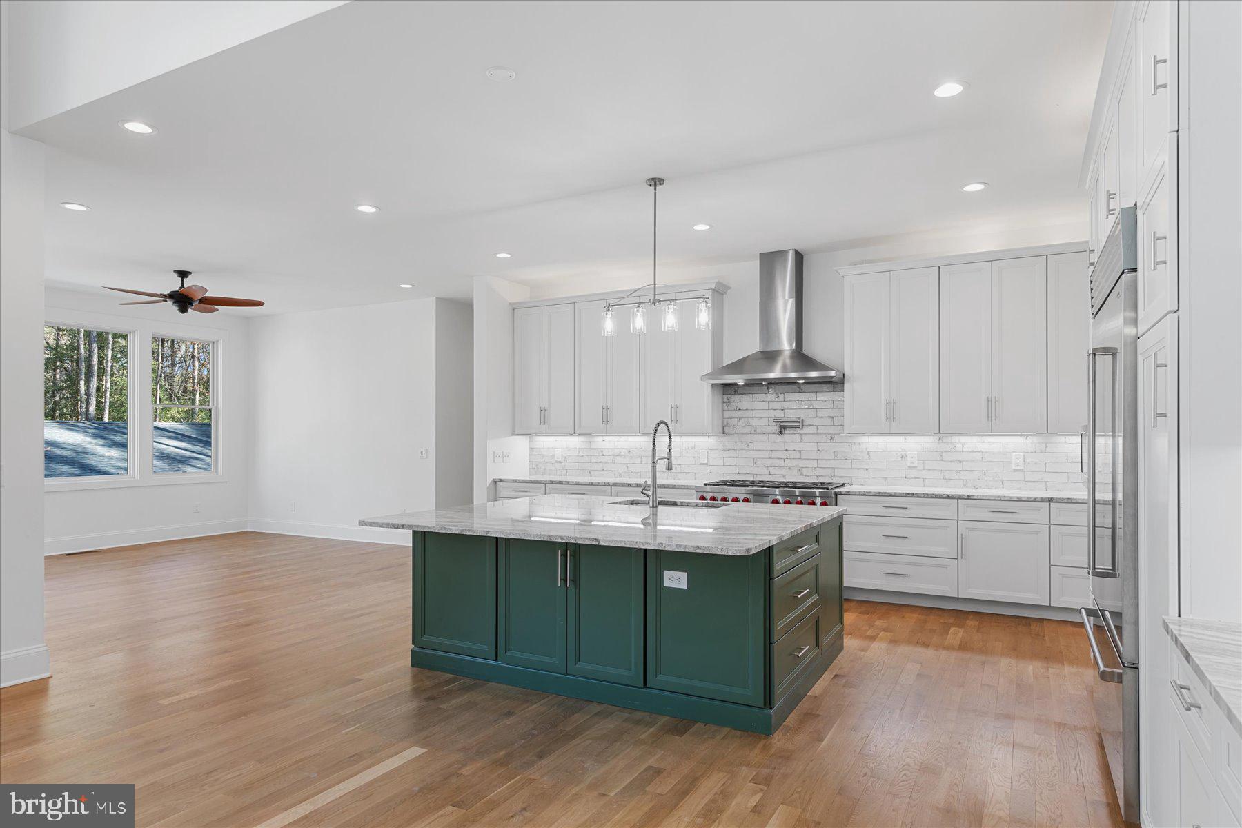30425 Hollymount Road Harbeson, DE 19951 - Photo 24 of 98 a kitchen with kitchen island granite countertop a sink stainless steel appliances and cabinets