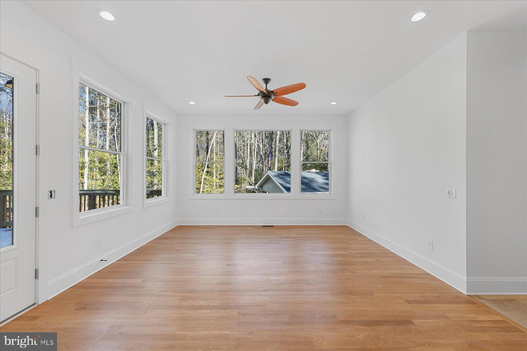 30425 Hollymount Road Harbeson, DE 19951 - Photo 26 of 98 an empty room with wooden floor and windows