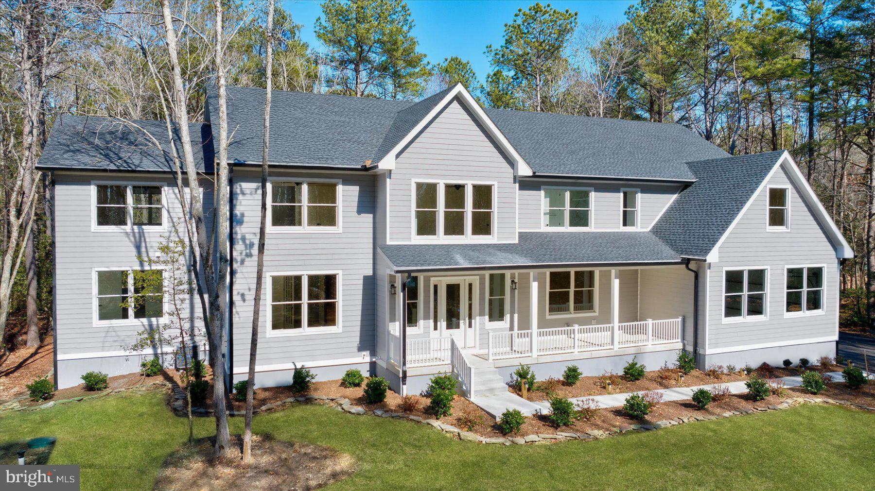 30425 Hollymount Road Harbeson, DE 19951 - Photo 3 of 98 a front view of a house with a yard