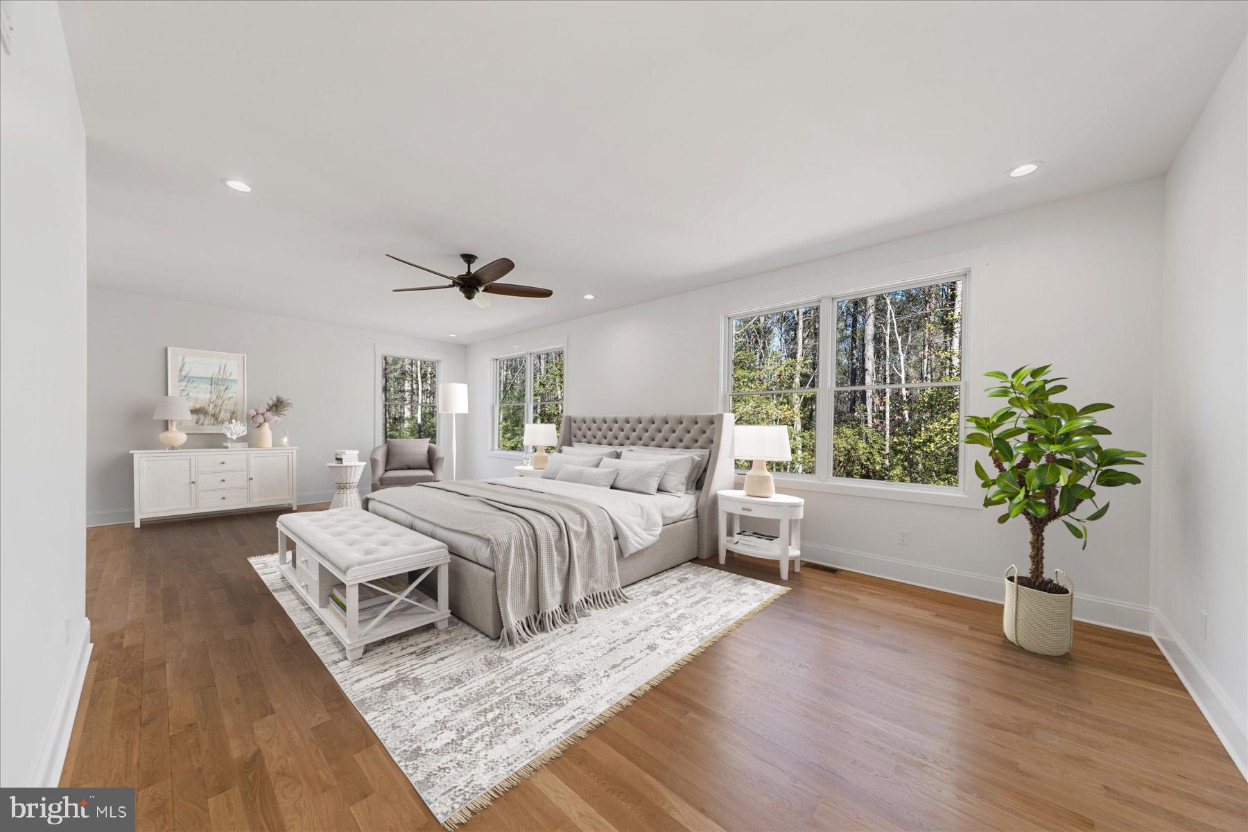 30425 Hollymount Road Harbeson, DE 19951 - Photo 37 of 98 a bedroom with a large bed and a potted plant