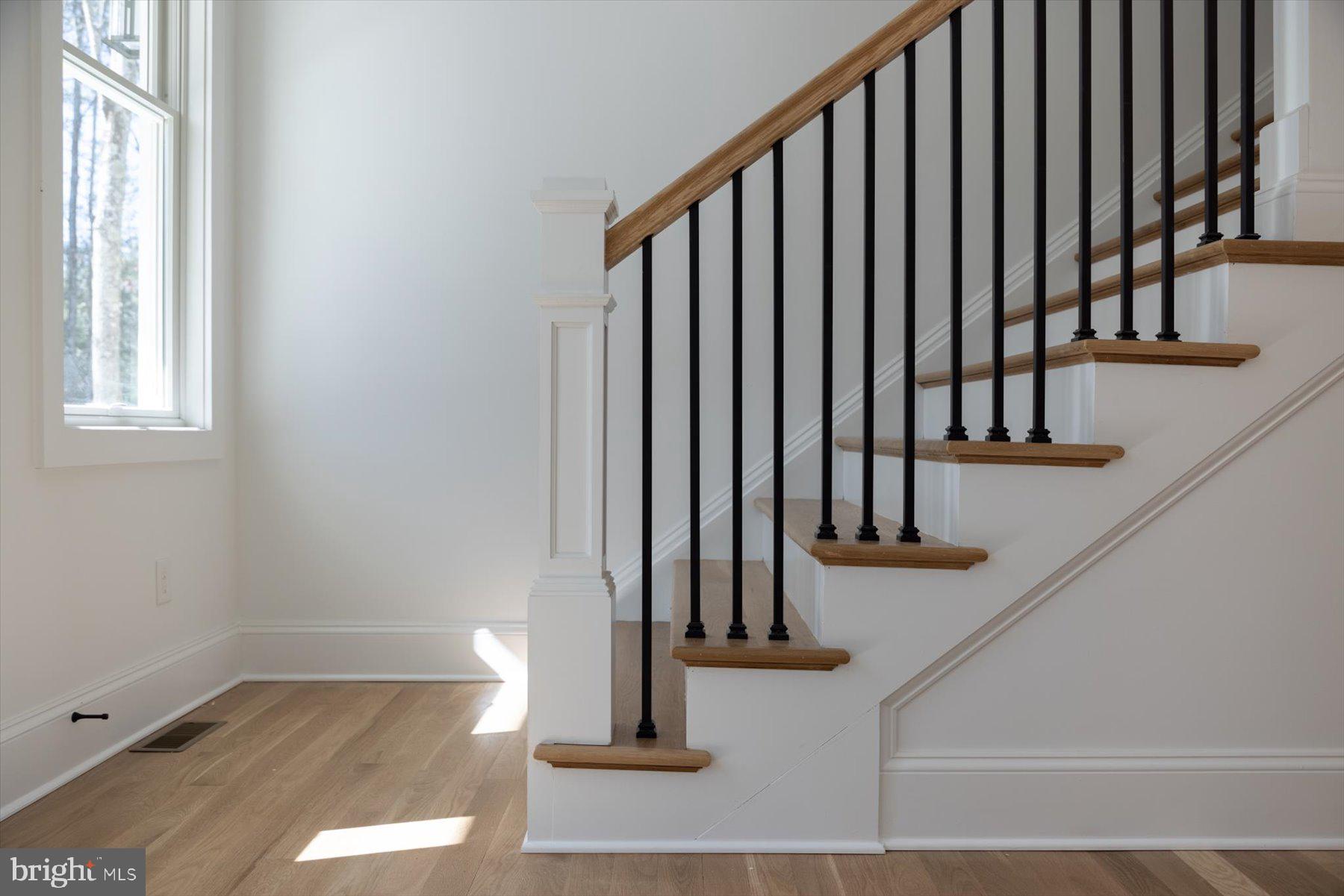 30425 Hollymount Road Harbeson, DE 19951 - Photo 48 of 98 a view of staircase with lots of frames on wall and a window