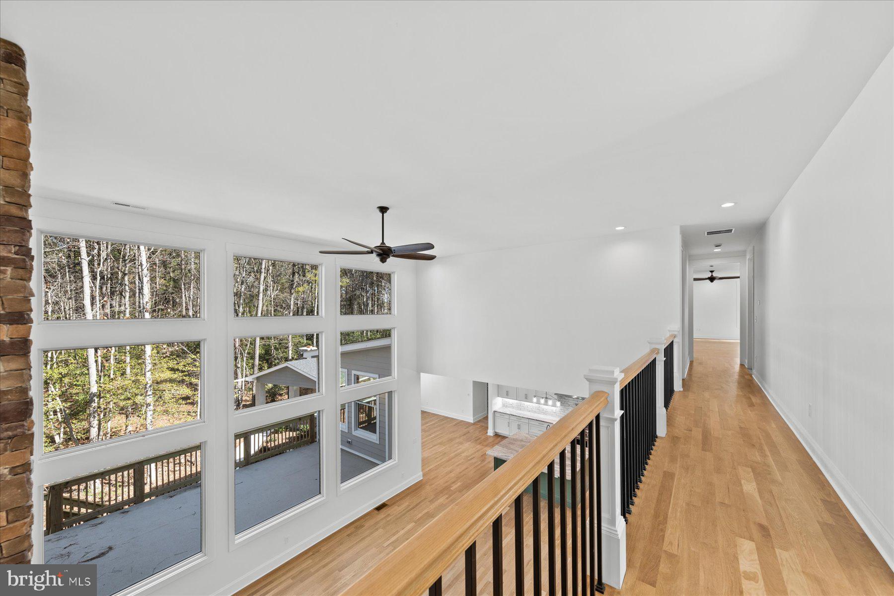 30425 Hollymount Road Harbeson, DE 19951 - Photo 49 of 98 a view of a hallway with furniture and wooden floor