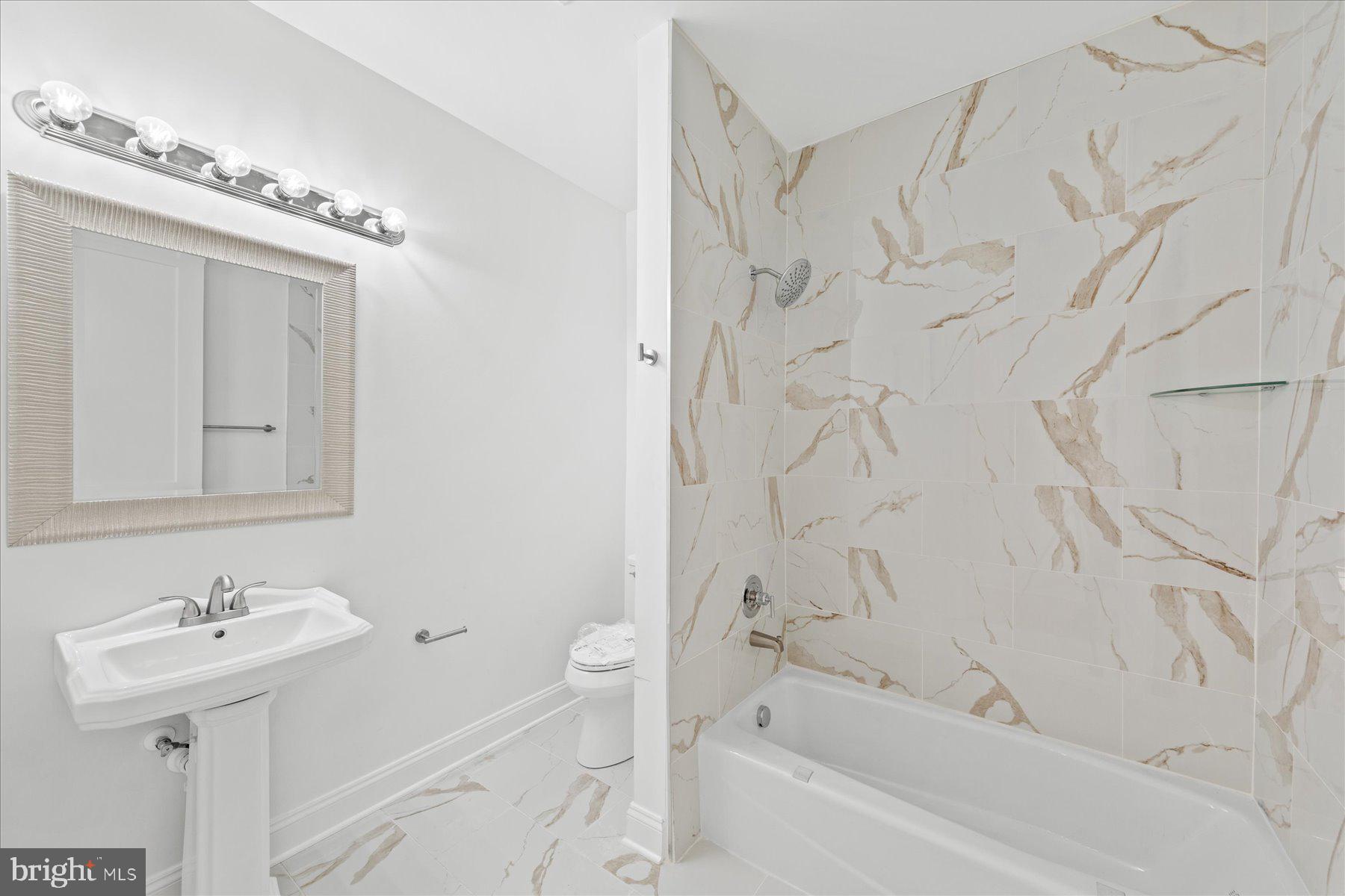 30425 Hollymount Road Harbeson, DE 19951 - Photo 57 of 98 a bathroom with a sink a toilet and bathtub