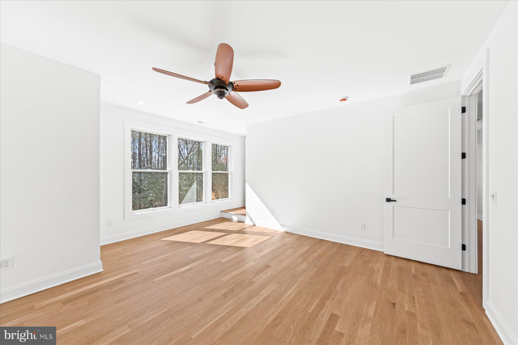 30425 Hollymount Road Harbeson, DE 19951 - Photo 59 of 98 a view of an empty room with a window and wooden floor